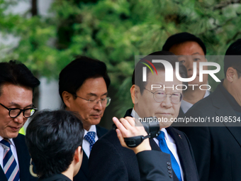 Lee Jae-myung (center), leader of the Democratic Party of Korea, leaves the Seoul Central District Court in Seocho-gu, Seoul, on November 25...