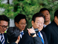 Lee Jae-myung (center), leader of the Democratic Party of Korea, leaves the Seoul Central District Court in Seocho-gu, Seoul, on November 25...