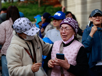 Supporters of Democratic Party leader Lee Jae-myung embrace each other in tears of joy outside the Seoul Central District Court in Seocho-gu...