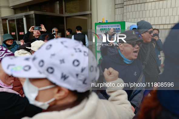 Democratic Party leader Lee Jae-myung's supporters and party members share moments of joy, embracing one another outside the Seoul Central D...