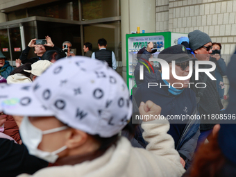 Democratic Party leader Lee Jae-myung's supporters and party members share moments of joy, embracing one another outside the Seoul Central D...