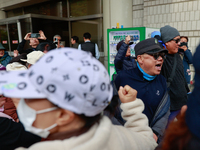 Democratic Party leader Lee Jae-myung's supporters and party members share moments of joy, embracing one another outside the Seoul Central D...