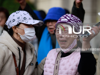 Supporters of Democratic Party leader Lee Jae-myung embrace each other in tears of joy outside the Seoul Central District Court in Seocho-gu...