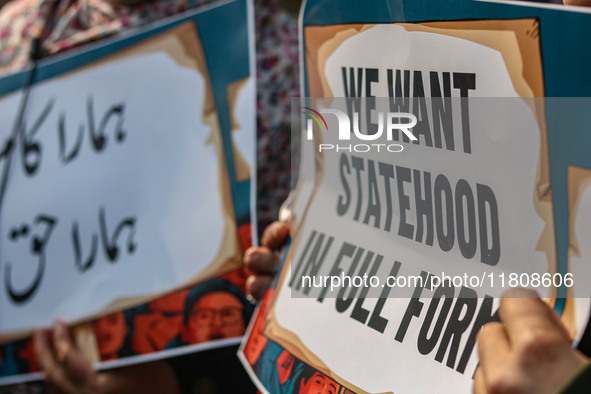 Female workers of the Jammu and Kashmir Pradesh Congress Committee (JKPCC) hold placards during a protest demanding the restoration of state...