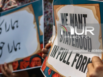 Female workers of the Jammu and Kashmir Pradesh Congress Committee (JKPCC) hold placards during a protest demanding the restoration of state...