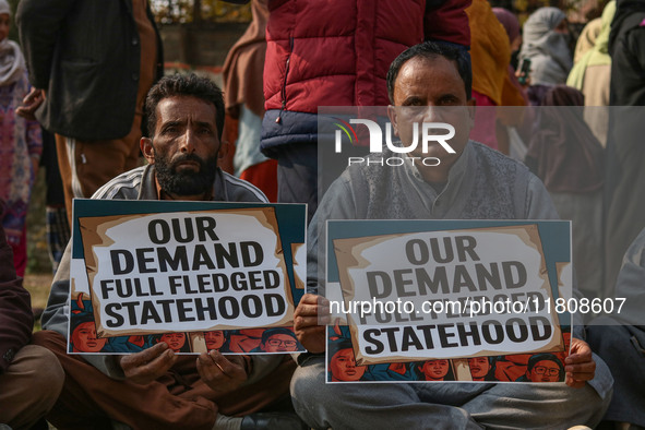 Members of the Jammu and Kashmir Pradesh Congress Committee (JKPCC) hold placards during a protest demanding the restoration of statehood an...