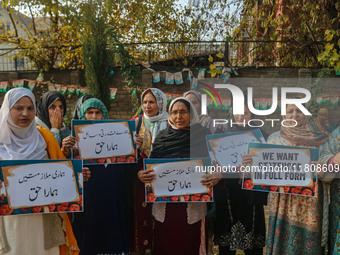 Female workers of the Jammu and Kashmir Pradesh Congress Committee (JKPCC) shout slogans and hold placards during a protest demanding the re...