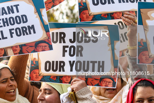 Female workers of the Jammu and Kashmir Pradesh Congress Committee (JKPCC) hold placards during a protest demanding the restoration of state...