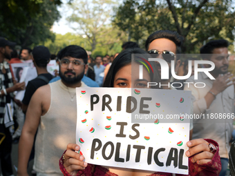 An LGBT supporter holds a placard reading 'pride is political' during the pride march in New Delhi, India, on November 24, 2024. (