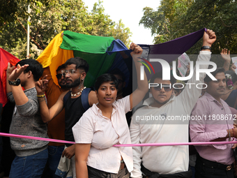 Members of the LGBT community hold the rainbow flag during the pride march in New Delhi, India, on November 24, 2024. (