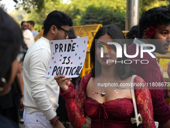 An LGBT supporter holds a placard reading 'pride is political' during the pride march in New Delhi, India, on November 24, 2024. (