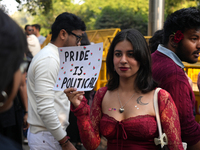 An LGBT supporter holds a placard reading 'pride is political' during the pride march in New Delhi, India, on November 24, 2024. (