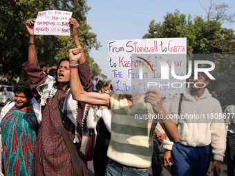 Supporters of the LGBT community hold placards in support of Kashmir and Palestine during the pride march in New Delhi, India, on November 2...