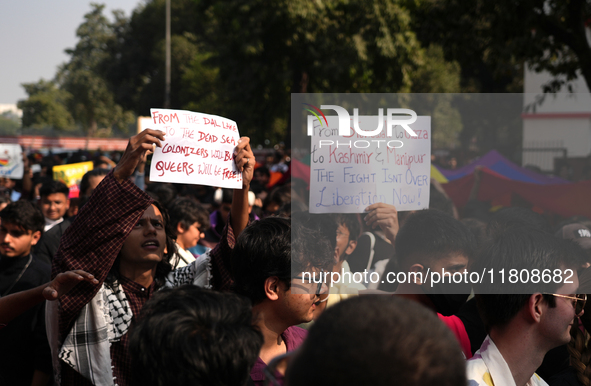 Supporters of the LGBT community hold placards in support of Kashmir and Palestine during the pride march in New Delhi, India, on November 2...