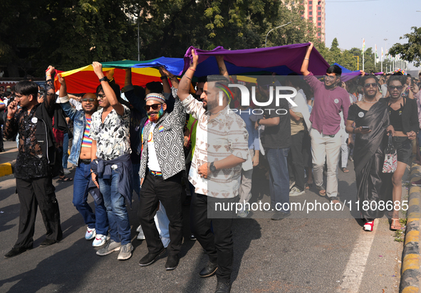 Members of the LGBT community walk with the rainbow flag during the pride march in New Delhi, India, on November 24, 2024. 