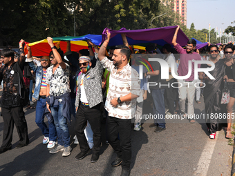 Members of the LGBT community walk with the rainbow flag during the pride march in New Delhi, India, on November 24, 2024. (