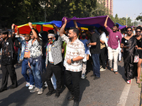 Members of the LGBT community walk with the rainbow flag during the pride march in New Delhi, India, on November 24, 2024. (