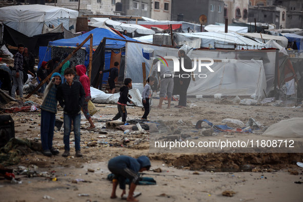 Palestinian displaced persons inspect their tents, which are damaged by wind and rain after heavy rainfall in Deir al-Balah, central Gaza St...