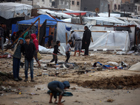 Palestinian displaced persons inspect their tents, which are damaged by wind and rain after heavy rainfall in Deir al-Balah, central Gaza St...