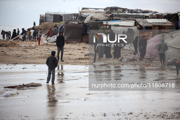 Palestinian displaced persons inspect their tents, which are damaged by wind and rain after heavy rainfall in Deir al-Balah, central Gaza St...