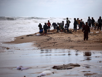 Palestinian displaced persons inspect their tents, which are damaged by wind and rain after heavy rainfall in Deir al-Balah, central Gaza St...