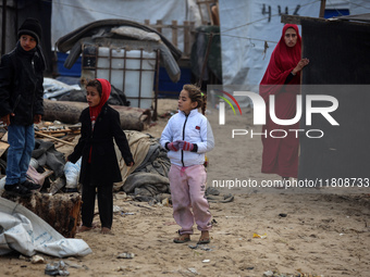 Palestinian displaced persons inspect their tents, which are damaged by wind and rain after heavy rainfall in Deir al-Balah, central Gaza St...