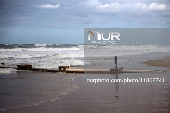 A Palestinian boy stands on the seashore after heavy rainfall in Deir al-Balah, central Gaza Strip, on November 25, 2024, amid the ongoing w...