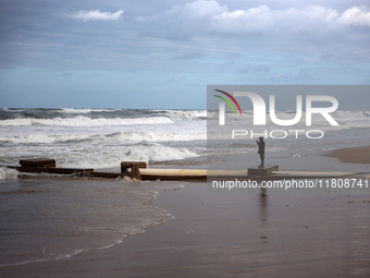 A Palestinian boy stands on the seashore after heavy rainfall in Deir al-Balah, central Gaza Strip, on November 25, 2024, amid the ongoing w...