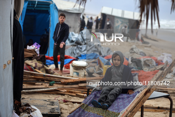 Palestinian displaced persons inspect their tents, which are damaged by wind and rain after heavy rainfall in Deir al-Balah, central Gaza St...