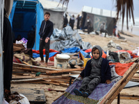 Palestinian displaced persons inspect their tents, which are damaged by wind and rain after heavy rainfall in Deir al-Balah, central Gaza St...