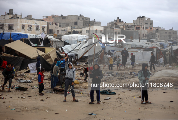 Palestinian displaced persons inspect their tents, which are damaged by wind and rain after heavy rainfall in Deir al-Balah, central Gaza St...