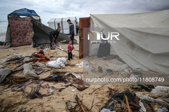 Palestinian displaced persons inspect their tents, which are damaged by wind and rain after heavy rainfall in Deir al-Balah, central Gaza St...