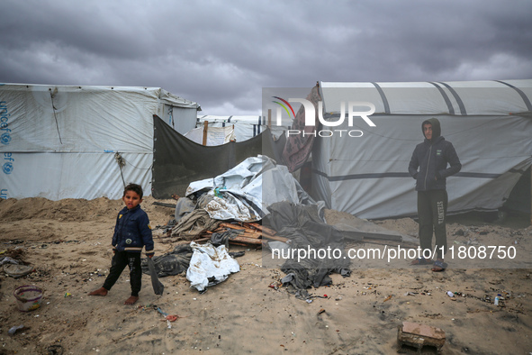 Palestinian displaced persons inspect their tents, which are damaged by wind and rain after heavy rainfall in Deir al-Balah, central Gaza St...