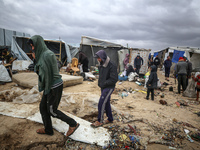 Palestinian displaced persons inspect their tents, which are damaged by wind and rain after heavy rainfall in Deir al-Balah, central Gaza St...