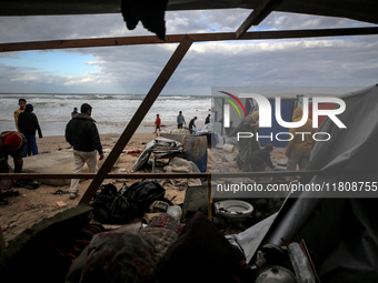 Palestinian displaced persons inspect their tents, which are damaged by wind and rain after heavy rainfall in Deir al-Balah, central Gaza St...