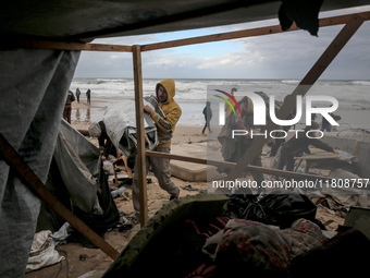 Palestinian displaced persons inspect their tents, which are damaged by wind and rain after heavy rainfall in Deir al-Balah, central Gaza St...