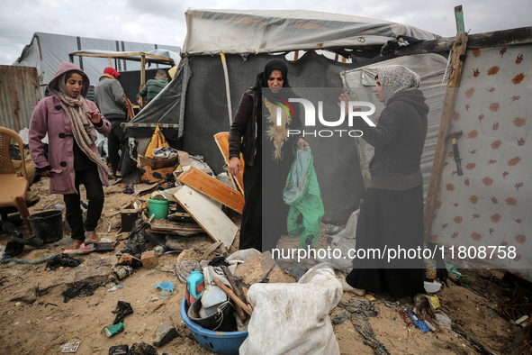 Palestinian displaced persons inspect their tents, which are damaged by wind and rain after heavy rainfall in Deir al-Balah, central Gaza St...