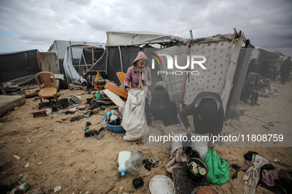 Palestinian displaced persons inspect their tents, which are damaged by wind and rain after heavy rainfall in Deir al-Balah, central Gaza St...