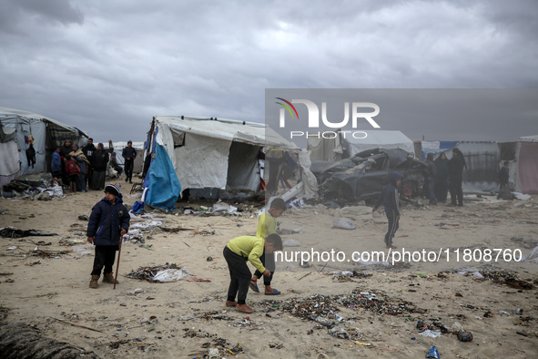 Palestinian displaced persons inspect their tents, which are damaged by wind and rain after heavy rainfall in Deir al-Balah, central Gaza St...