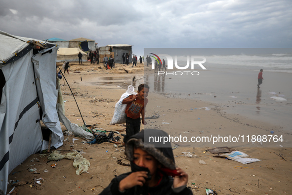 Palestinian displaced persons inspect their tents, which are damaged by wind and rain after heavy rainfall in Deir al-Balah, central Gaza St...