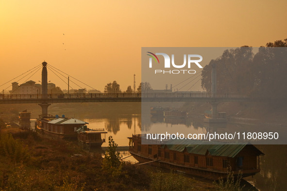 People walk over a bridge in Srinagar, Jammu and Kashmir, on November 25, 2024. 