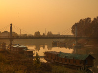 People walk over a bridge in Srinagar, Jammu and Kashmir, on November 25, 2024. (