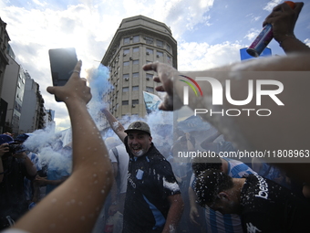 Supporters of Racing Club celebrate the victory of the 2024 Copa Sudamericana in Buenos Aires, Argentina, on November 24, 2024. A massive ga...