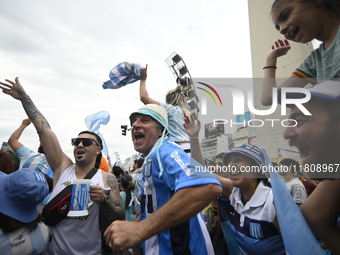 Supporters of Racing Club celebrate the victory of the 2024 Copa Sudamericana in Buenos Aires, Argentina, on November 24, 2024. A massive ga...