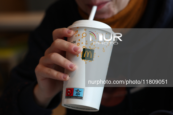 A person drinks in McDonald's restaurant in Poland on November 24, 2024. 