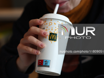 A person drinks in McDonald's restaurant in Poland on November 24, 2024. (