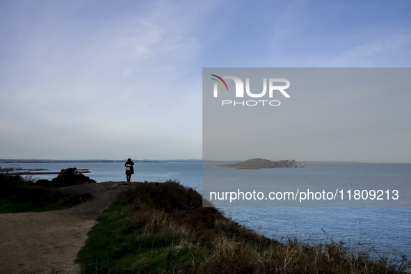 A person looks at the Howth Cliff Walk in Howth, Ireland, on November 2024. 