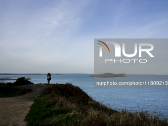 A person looks at the Howth Cliff Walk in Howth, Ireland, on November 2024. (