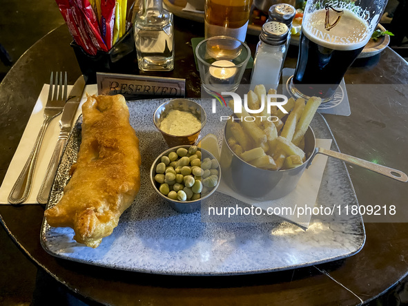 A typical fish and chips and a pint of Guinness are seen in the O'Connels Pub in Howth, Ireland, on November 2024 