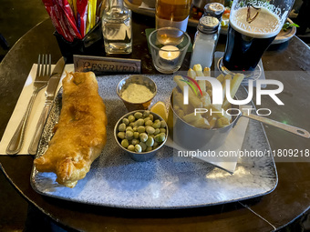 A typical fish and chips and a pint of Guinness are seen in the O'Connels Pub in Howth, Ireland, on November 2024 (